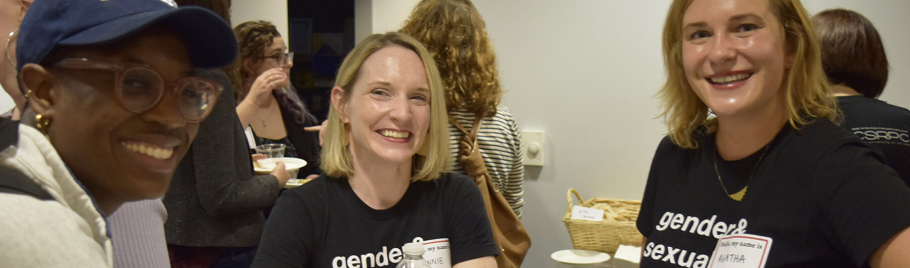 Three people smiling at camera.
