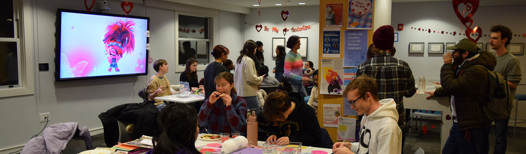 People seated and standing mingling with each other.