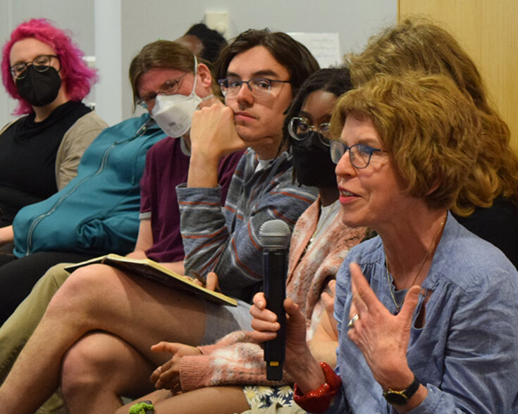 People seated and speaking.