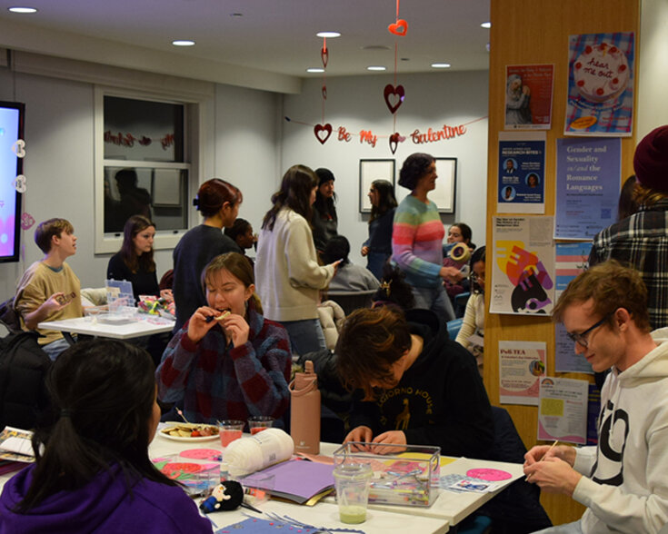 People seated and standing mingling with each other.